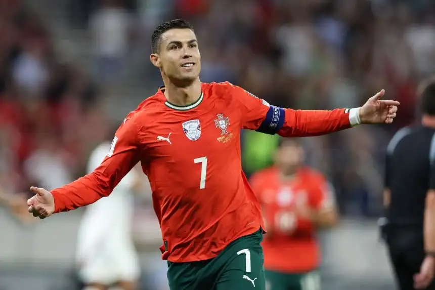 Cristiano Ronaldo celebrating a goal for Portugal, showcasing his status as the all-time leading goalscorer.